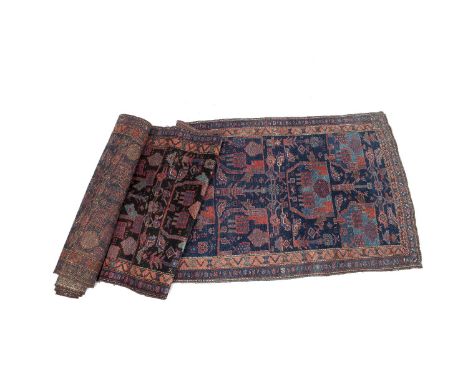 A SEMI-ANTIQUE KOLYAI RUNNER, West Persia, c.1920-1930, the large centre field woven with plants, figures and animals in pale