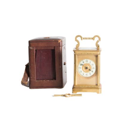A 19TH CENTURY FRENCH GILT BRASS TRAVELLING CARRIAGE CLOCK, within a fitted case, the swing bracket handle above a circular e