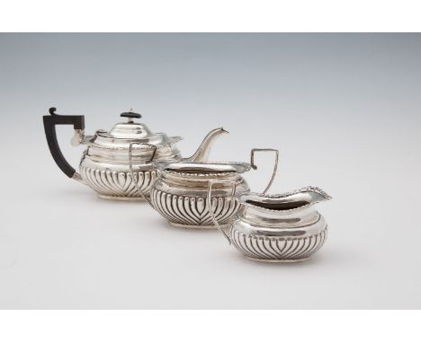 ***PLEASE NOTE: date should read 1914***A THREE PIECE SILVER TEASET, Chester 1914, comprising teapot, twin handled sugar bowl