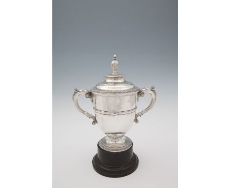 A LARGE TWIN HANDLED SILVER CUP AND COVER, London 1934, mark of R & S Garrard & Co (Sebastian Henry Garrard), retailed by Gar