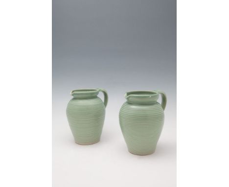 A PAIR OF ART DECO LOVATTS WARE EWERS, of baluster form, decorated in light green tones with concentric ribbed body, applied 