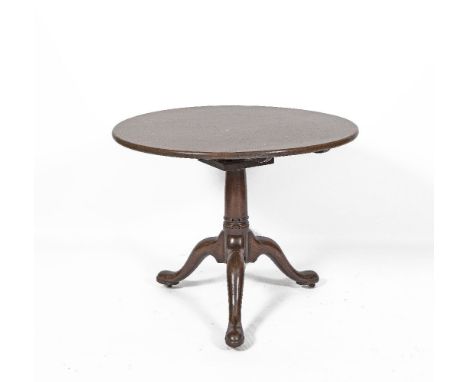 A GEORGE III MAHOGANY CIRCULAR TILT-TOP LOW TABLE, plain top, on bird cage mechanism, tripod base on pad feet and castors. 85
