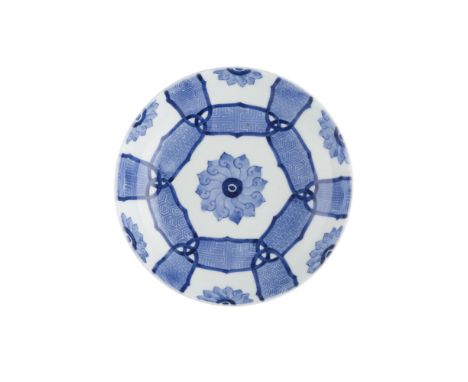 NABESHIMA BLUE AND WHITE DISHEDO PERIOD painted with a stylised lotus flowerhead surrounded by interlocked cartouches enclosi