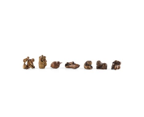 COLLECTION OF SEVEN WOODEN NETSUKE20th Centurymostly carved from boxwood, comprising: a kappa perched on a large koi fish, si