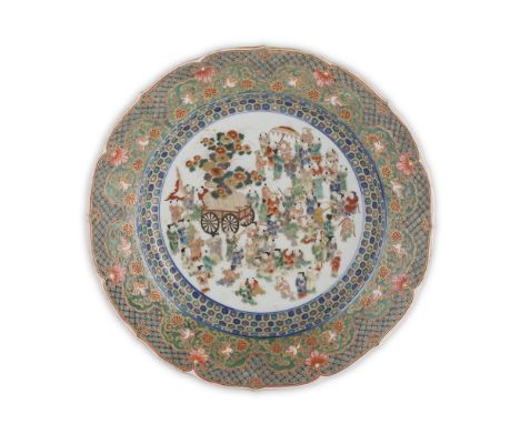 KANGXI-STYLE IMARI 'BOYS' CHARGERMEIJI PERIOD elaborately painted to the centre with a procession of boys to celebrate a youn