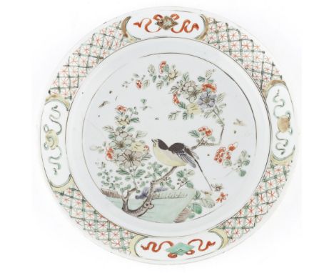 FAMILLE VERTE PLATEKANGXI PERIOD painted with a bird perched on flowering peach branches, surrounded by a diaper border with 