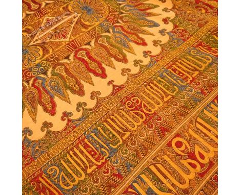 A vintage table cover having multicoloured designs and Islamic inscription reading 'I am from God, I will go to God'