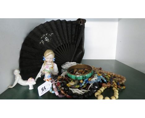 A vintage fan, early 20th century dressing table dolls and beads