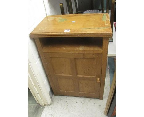 A light oak Thomas Mouseman cabinet having a single shelf over a panelled door with turned knop, on block feet