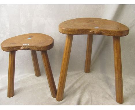 Two light oak Thomas Mouseman stools having kidney shaped tops over splayed legs