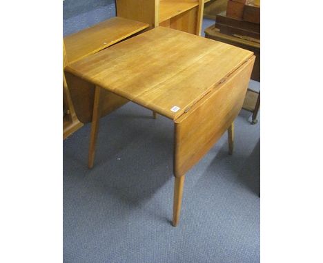 A 1960s retro Ercol light elm fall flap table on circular  splayed legs