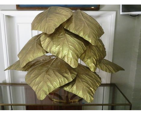 A retro 1970s gilt metal floor standing lamp designed as a spray of leaves, each concealing a light fitting, on a circular ba