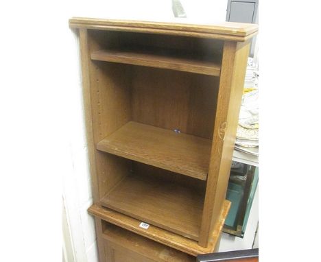 A light oak Thomas Mouseman open bookcase having two adjustable shelves on block feet
