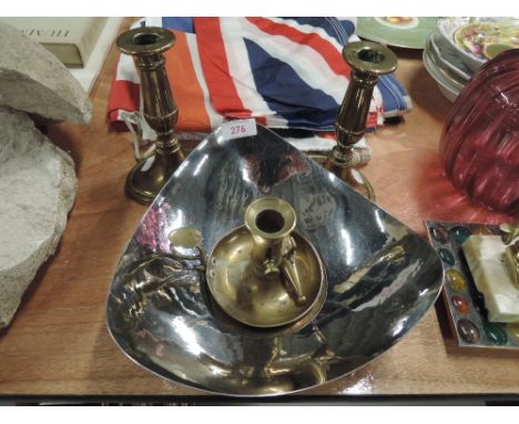 A pair of brass candlesticks , a chamber stick and planished bowl