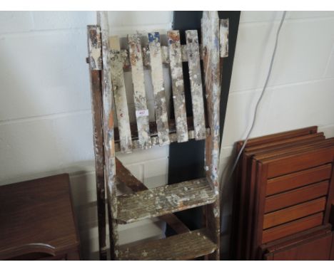 A set of vintage wooden decorators step ladders