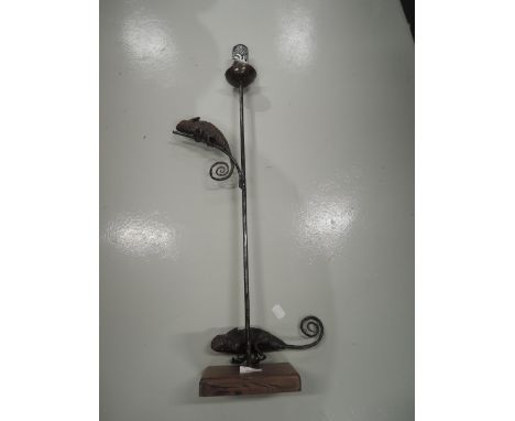 A novelty candle stick with metal chameleon decoration 