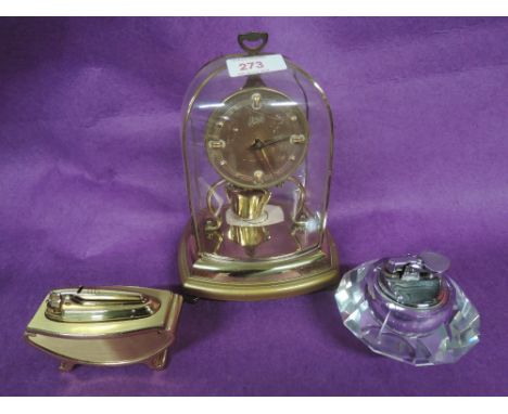 A vintage carriage clock and two table lighters