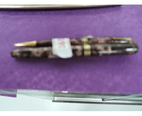 A vintage Conway Stewart green marble fountain pen body and a Waterman Fountain pen in a Parker box