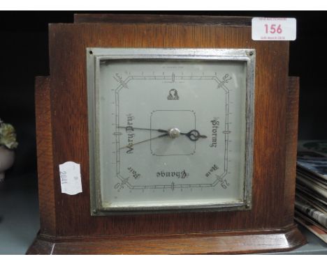 A vintage wall mounted barometer by Smiths