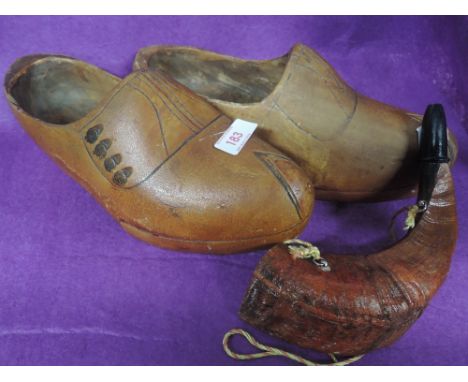 A pair of vintage wooden carved clogs in a Dutch style