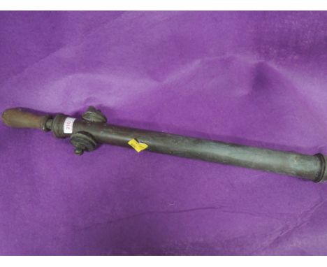 A vintage stirrup pump
