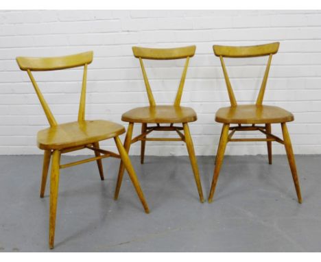 A set of three vintage Ercol stacking chairs with curved backs and solid seats on tapering supports, 75 x 40cm (3) 