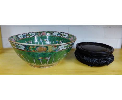 A Chinese canton enamel bowl, the green ground with butterflies and flowers in coloured enamels with a stylised motif to the 