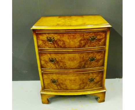 A burr walnut veneered bow front three drawer chest on bracket supports, 57 x 73cm