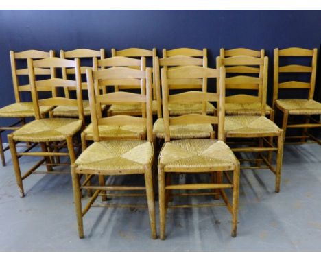 A set of twelve ladder back oak chairs with rush seats (12)