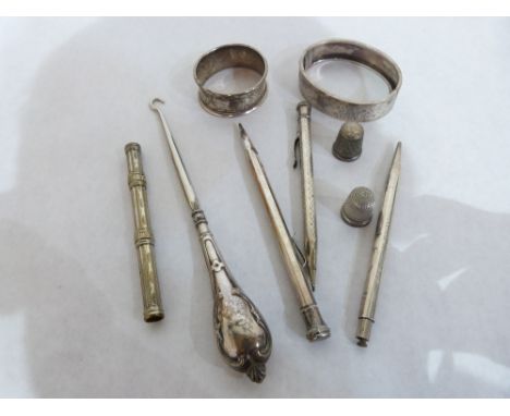 A silver bangle, a silver napkin ring, a silver handled buttonhook, four plated pens and two silver thimbles