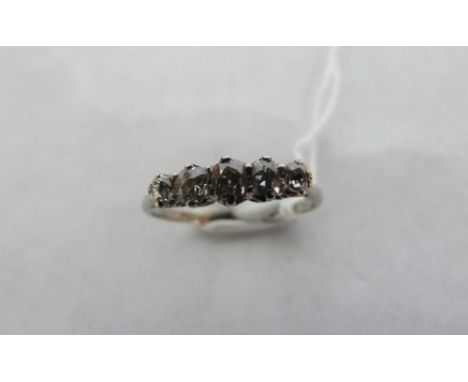 A five stoned diamond ring, the setting 14mm wide. In 18ct white gold and platinum. Size R. 2.8g gross