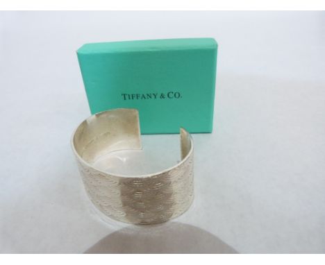 A Tiffany and Co. silver bangle. Marked 925 and dated 1997 incuse. Boxed.