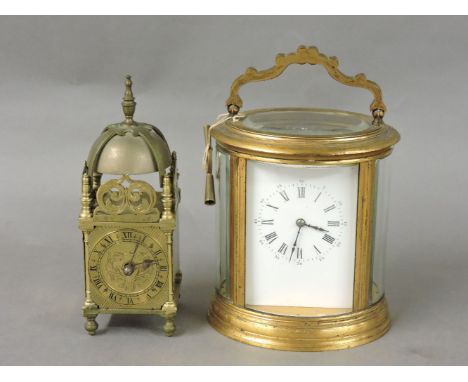 An oval gilt brass carriage clock, striking on a gong, together with a miniature lantern clock