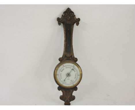 A carved oak barometer