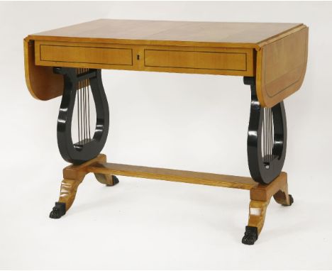 A Biedermeier style maple and ebonised sofa table, circa 1900, the drop leaf ends over one long frieze drawer and lyre shaped