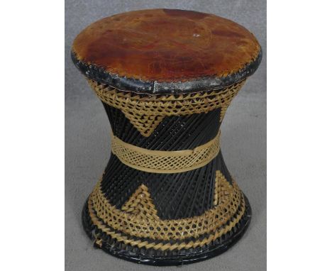 A vintage Indian wicker stool with leather seat. H.43 D.39cm 