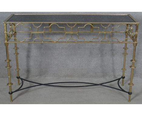 A contemporary gilt metal console table with fretwork frieze on stretchered supports. H.80 W.120 D.40cm 