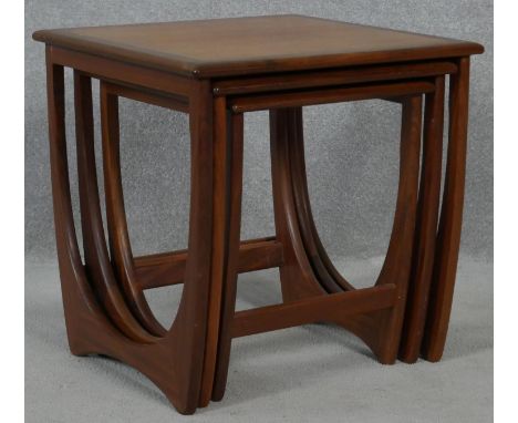 A nest of three 1970's vintage teak graduating occasional tables on shaped stretchered supports. H.51 L.50 W.50cm 