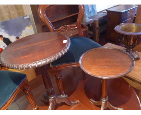 Two mahogany occasional tables raised on tripod supports, one with carved detail