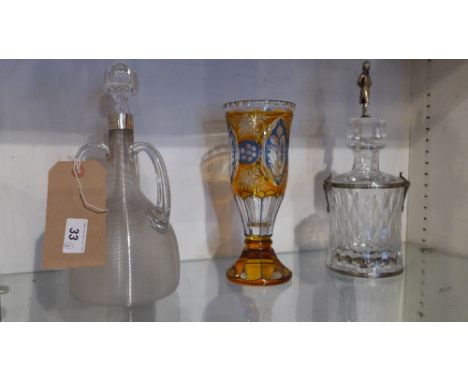 A late Victorian decanter having a silver collar, three handles and matchstriker body together with a Bohemian glass vase and