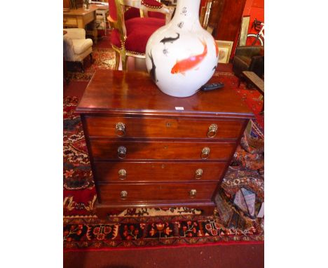 A Georgian mahogany chest of four long graduated drawers on bracket feet