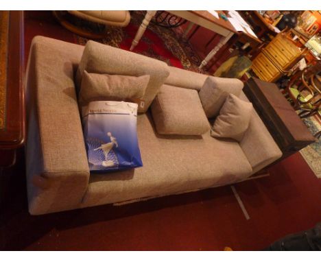 A contemporary and unused sofa in light beige hessian upholstery