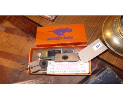 A collection of magic lantern slides, including rotating examples, together with a magic lantern in original box 