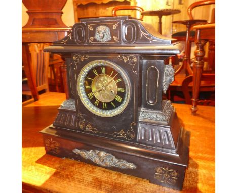 A large late Victorian slate marble mantle clock, the dial with Roman numerals, and the clock decorated with gilt metal mount