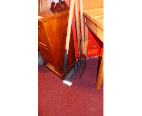 A collection of vintage agricultural tools 