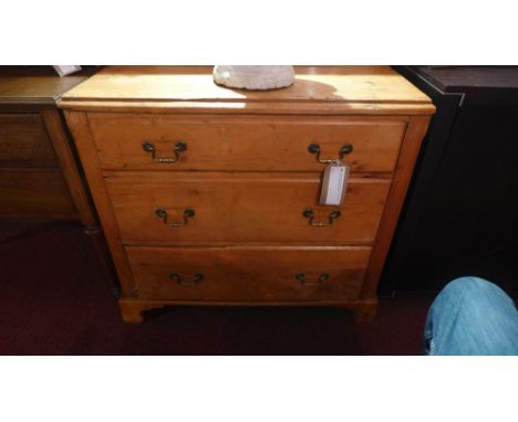 A George III pine chest of three graduated drawers, raised on shaped bracket feet