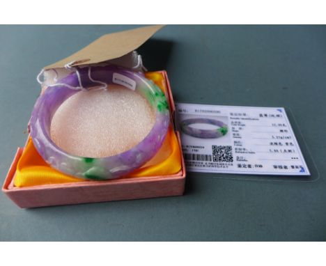 A Chinese carved jade bangle with certificate 