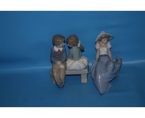 A NAO FIGURE GROUP - BOY AND GIRL TOGETHER WITH A NAO FIGURINE OF A GIRL