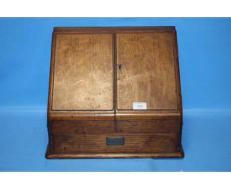 A VINTAGE OAK STATIONARY CABINET WITH CALENDAR