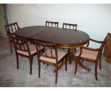 A MAHOGANY EXTENDING DOUBLE PEDESTAL DINING TABLE AND SIX CHAIRS INCLUDING TWO CARVERS